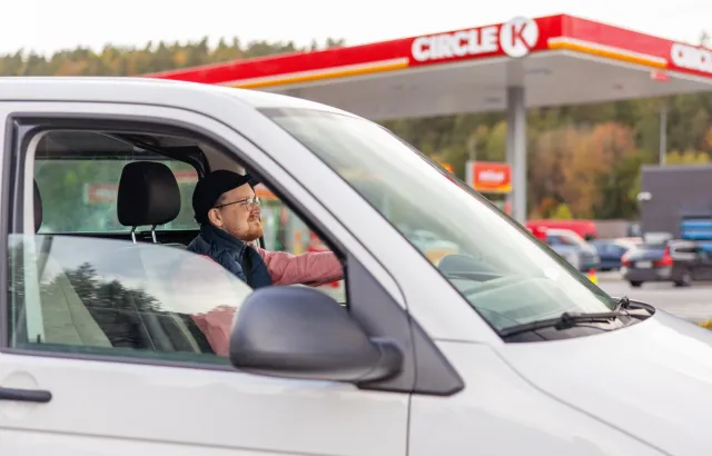 Man driving his van through a Circle K station