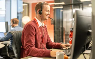 A person wearing a headset and a microphone at a Circle K office